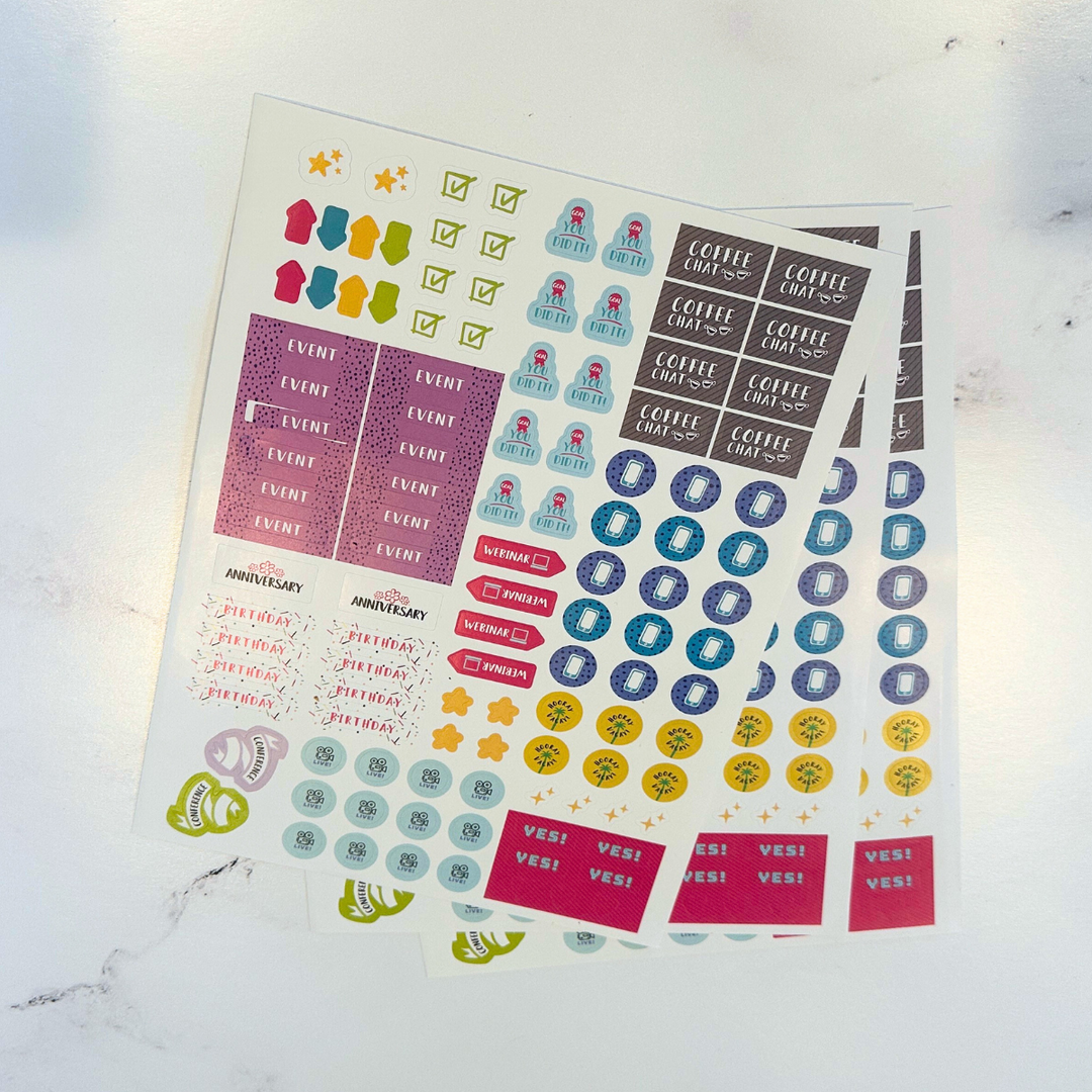 Set of colorful planner stickers on a white surface